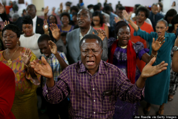 EULESS, TX - OCTOBER 05: Parishioners pray together during a church service at New Life Fellowship Church on October 5, 2014 in Euless, Texas. The congregation is made up of many people from Liberia where the first Ebola patient in America, Thomas Eric Duncan, lived before traveling to America with the virus. The service, led by Pastor Nathan Kortu, Jr., was an opportunity for the congregation to pray for their home country as well as their community and the family of Mr. Duncan. (Photo by Joe Raedle/Getty Images)